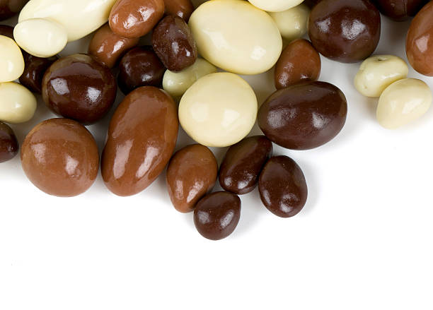 istock chocolate covered nuts and raisins isolated on white 613129208