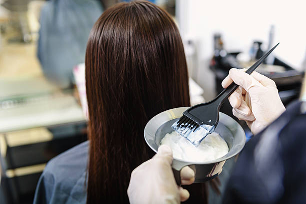 istock barber applying gel at barbershop 613129356