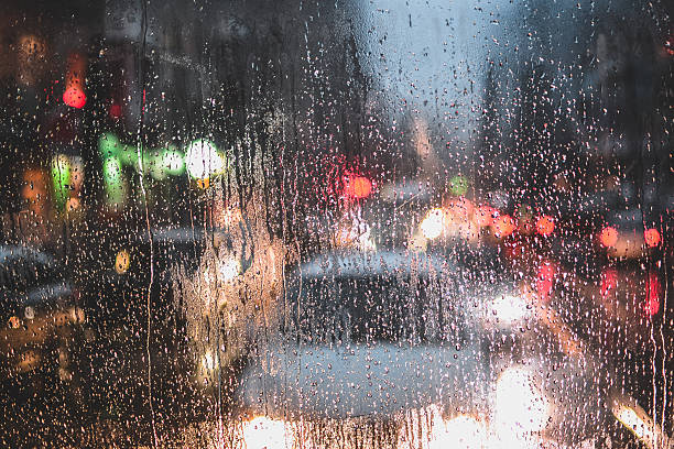istock Rain drops on window and blurred traffic lights 613130124