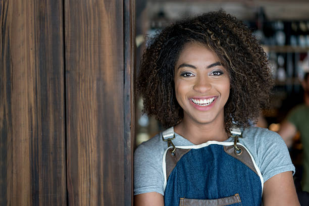 istock Happy woman working at a restaurant 613131964