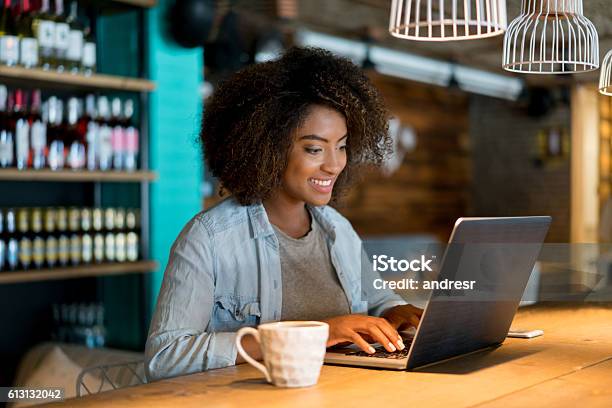 Casual Woman Working At A Cafe Stock Photo - Download Image Now - Owner, Laptop, Service