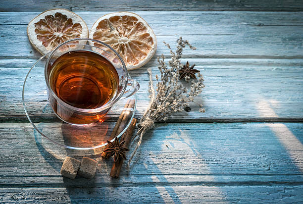 istock Cup of tea and dry twig herb top view 613132054