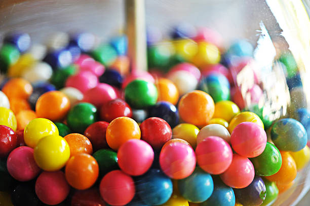 Gumballs Multi colored gum balls in a gum ball machine. gumball machine stock pictures, royalty-free photos & images