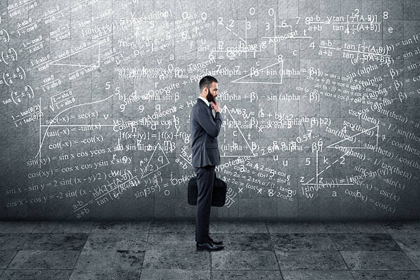 istock Thoughtful businessman standing in front of wall 613133478