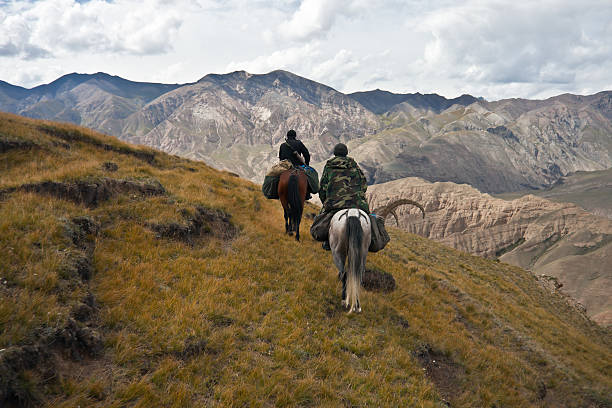 istock Hunters two horses returned with a trophy after a hunt 613133752