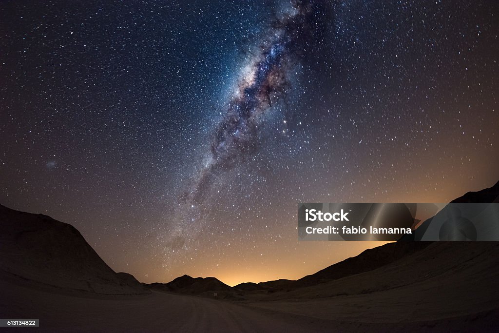 The Milky Way arc over the Namib desert, Namibia Starry sky and Milky Way arc, with details of its colorful core, outstandingly bright, captured from the Namib desert in Namibia, Africa. The Small Magellanic Cloud on the left hand side. Milky Way Stock Photo