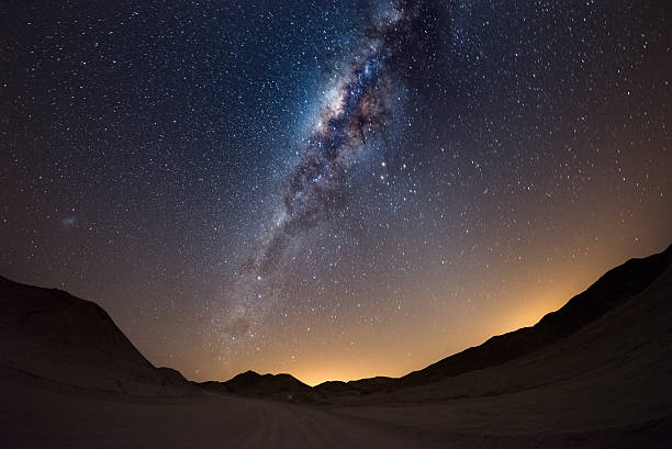 The Milky Way arc over the Namib desert, Namibia Starry sky and Milky Way arc, with details of its colorful core, outstandingly bright, captured from the Namib desert in Namibia, Africa. The Small Magellanic Cloud on the left hand side. milky way stock pictures, royalty-free photos & images