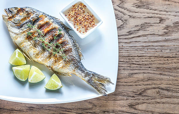 istock Grilled Dorade Royale Fish on the plate 613135790