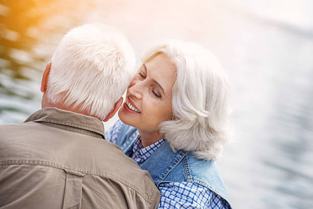 istock Mature loving couple has romantic date in park 613141560