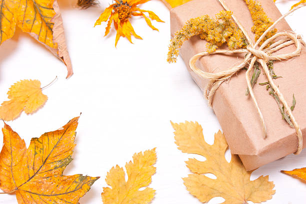 istock Present on the background blurred yellow leaves. 613141986