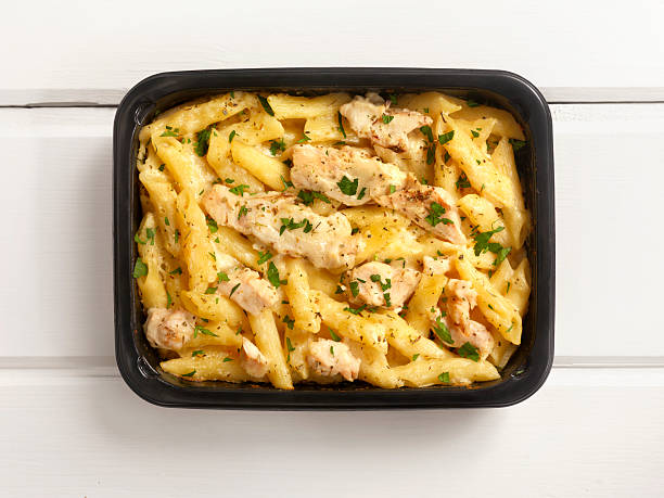 Microwave Dinner -Chicken and Penne Alfredo Microwave Dinner -Chicken and Penne Alfredo-Photographed on Hasselblad H3D2-39mb Camera ready to eat stock pictures, royalty-free photos & images