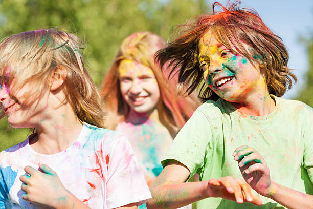istock Cute kids smeared with colored powder on Holi fest 613143160