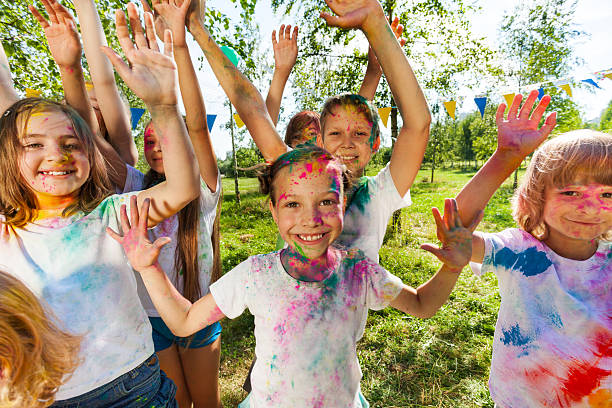 portrait of bright kids smeared in colored powder - face powder imagens e fotografias de stock