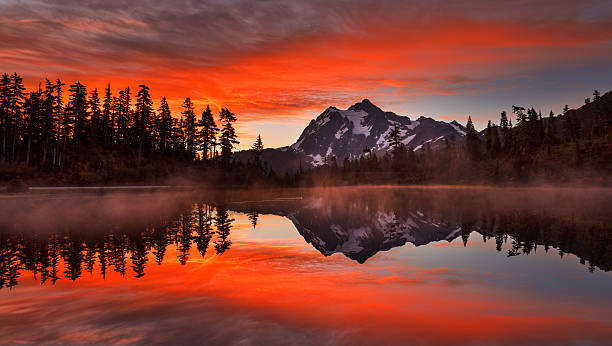 Mt Shuksan at Sunrise Mt Shuksan reflected in Picture Lake is the most beautiful and popular place in Heather Meadows, Mt Baker NF. picture lake stock pictures, royalty-free photos & images