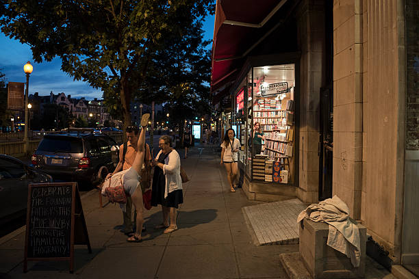Washington DC, USA - June 30, 2016: After exiting Kramerbooks & Afterwards, a well known indie bookstore and cafe at Washington DC's Dupont Circle, a young woman takes a stretch.