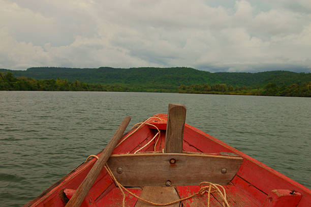 istock Fisherman's Boat on a River in Rural Cambodia 613144250
