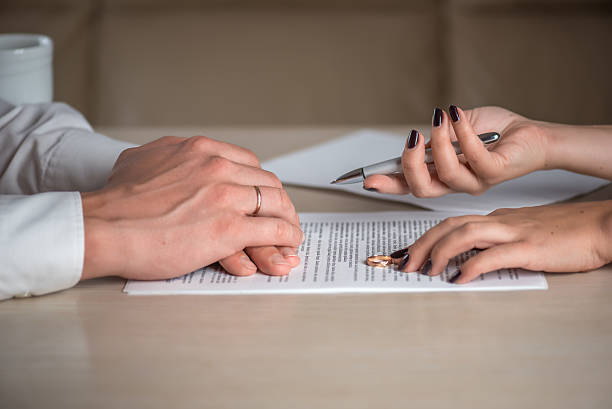 istock Wife and husband signing divorce documents, woman returning wedding ring 613144718