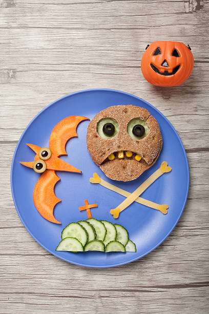 istock Halloween skull and bat made of bread and vegetables 613144950