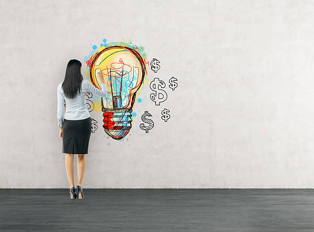 istock Woman working on light bulb sketch 613145362