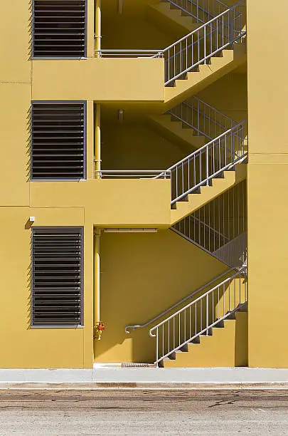 View of generic building with exterior stairs and yellow walls