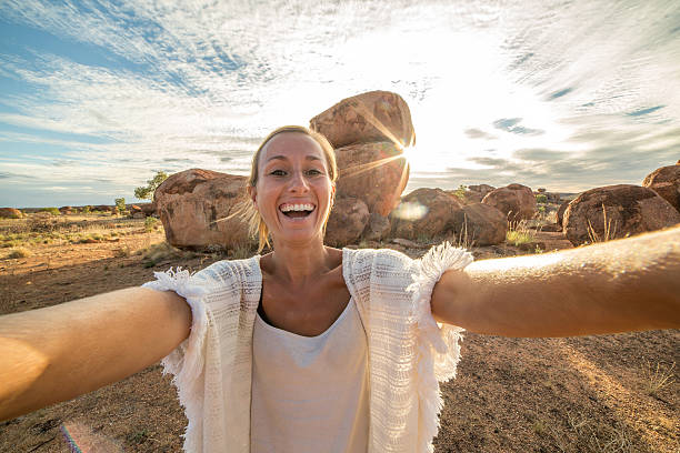 istock Personal perspective of woman visiting Devil's Marbles, Australia 613146828