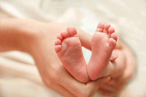 istock Soles of Newborn Feet.Father's Hands.Selective Focus 613146944
