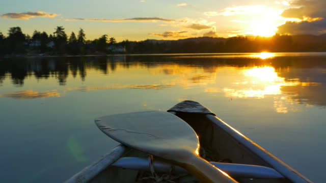 Canoe on Lake, Nature Adventure, Dusk Sunset on Still Ocean Water