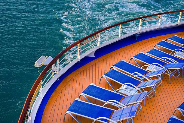 istock Blue sunbeds on a deck of a cruise ship 613208460