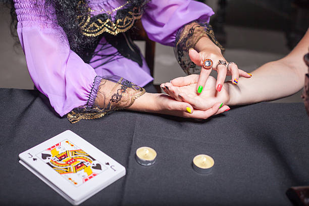 istock Sorceress reading somebody's hand 613208510