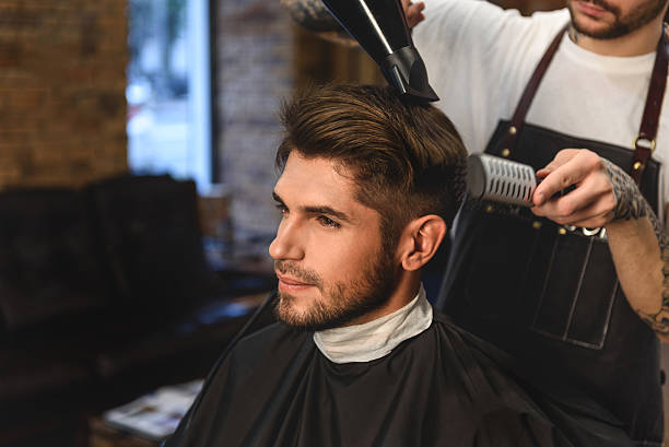 istock stylist with hairdryer and comb 613208936