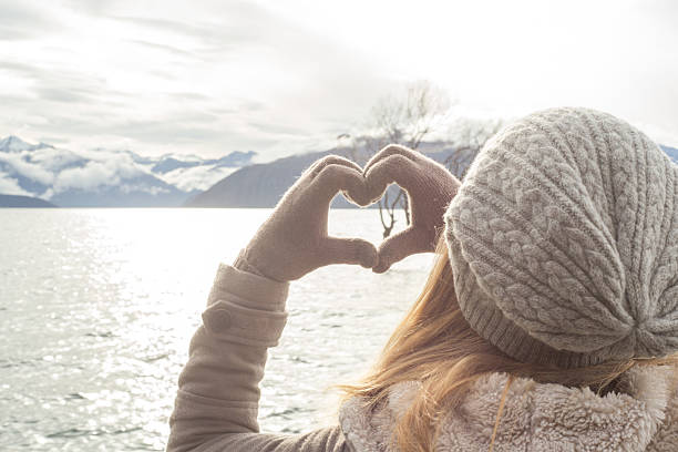 istock Woman frames the Lone tree at lake Wanaka into heart 613210016