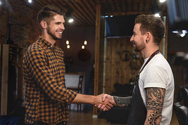istock handshake of two guys at barbershop 613210218