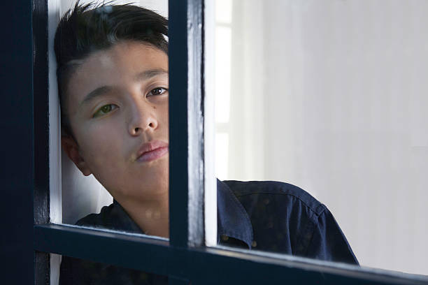 Boy Behind Window 460+ Boy Staring Out Of Window Stock Photos, Pictures & Royalty-Free ...