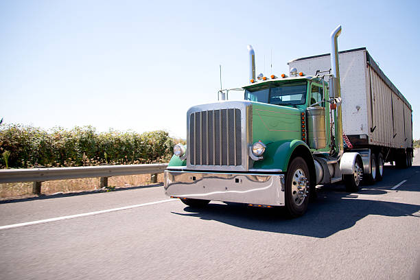 istock Big rig attractive green semi truck with bulk trailer 613214364