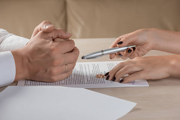istock Wife and husband signing divorce documents, woman returning wedding ring 613215930