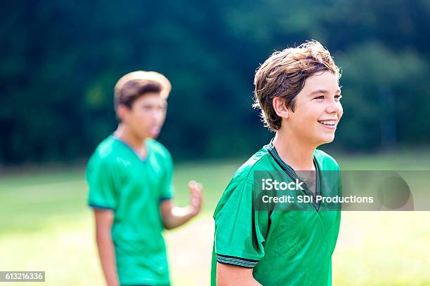 Happy Athlete During Soccer Game Stock Photo - Download Image Now - Kids' Soccer, Green Color, Sports Uniform