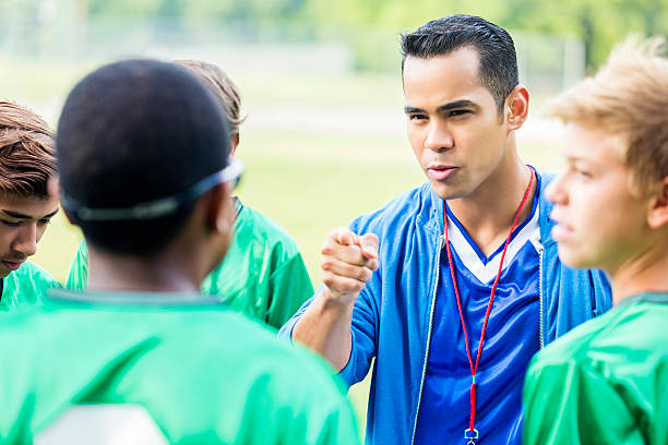 istock Serious soccer coach motivates his team during time out 613216496