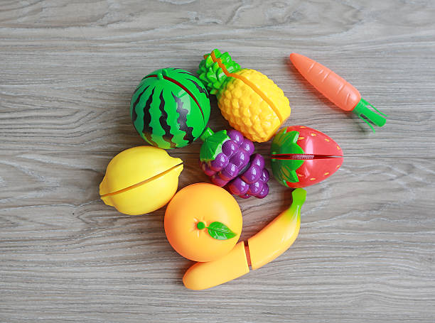 istock Plastic fruits on wood background, Children's toy 613216896