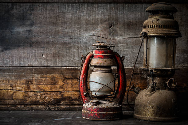 istock Old fashioned vintage kerosene oil lantern lamp burning 613217128