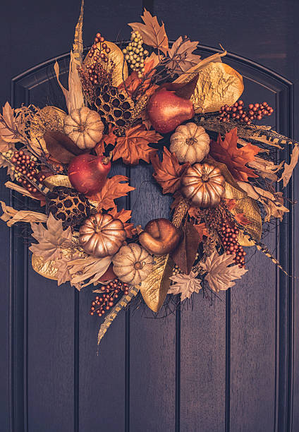 istock Ornate fall wreath with gold pumpkins hanging on front door 613218168