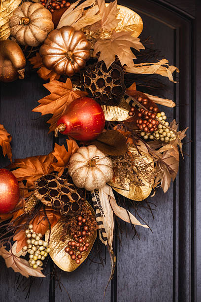 istock Ornate fall wreath with gold pumpkins hanging on front door 613218200