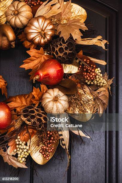 Ornate Fall Wreath With Gold Pumpkins Hanging On Front Door Stock Photo - Download Image Now