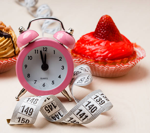 istock Sweet food measuring tape and clock on table 613219926