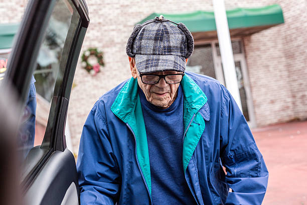 istock Elderly Man Warmly Dressed For Winter Shopping Trip Approaching Car 613221378