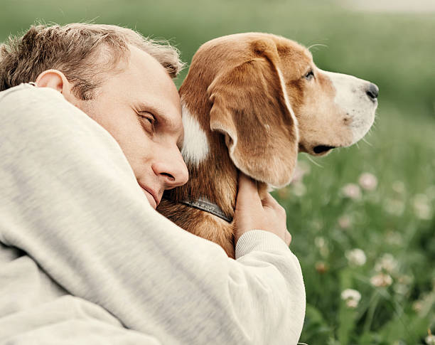 istock Man hugs his favorite dog 613221850
