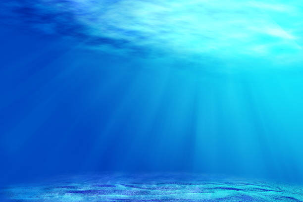istock underwater backgrounds with sun ray and water ripple. 613223336