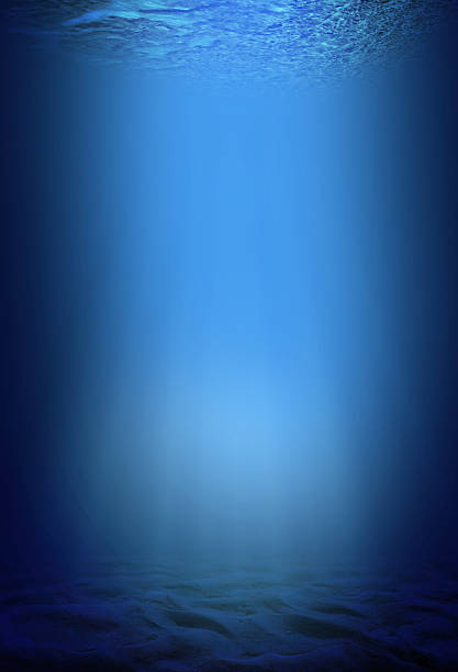 istock underwater backgrounds with sun ray and water ripple 613223408