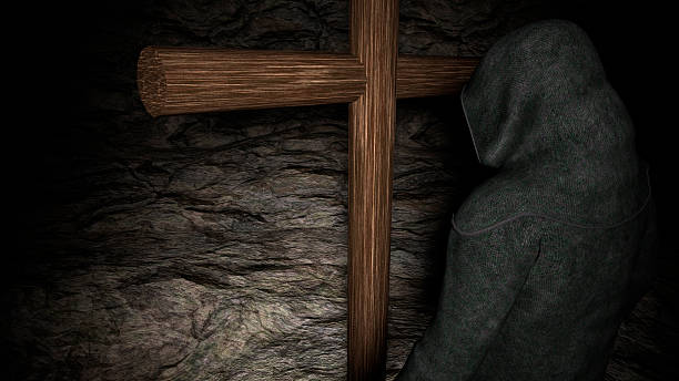 istock Christian monk with his head bowed, meditating 613225908