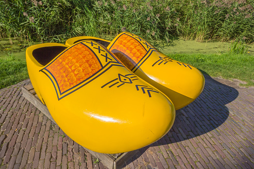 Zaanse Schans, Netherlands - September 13, 2016: Pair of large yellow wooden shoes in Zaanse Schans, Holland