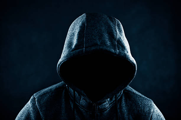 istock Hooded man in the dark 613227080